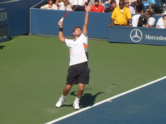 Tennis player serving during a match